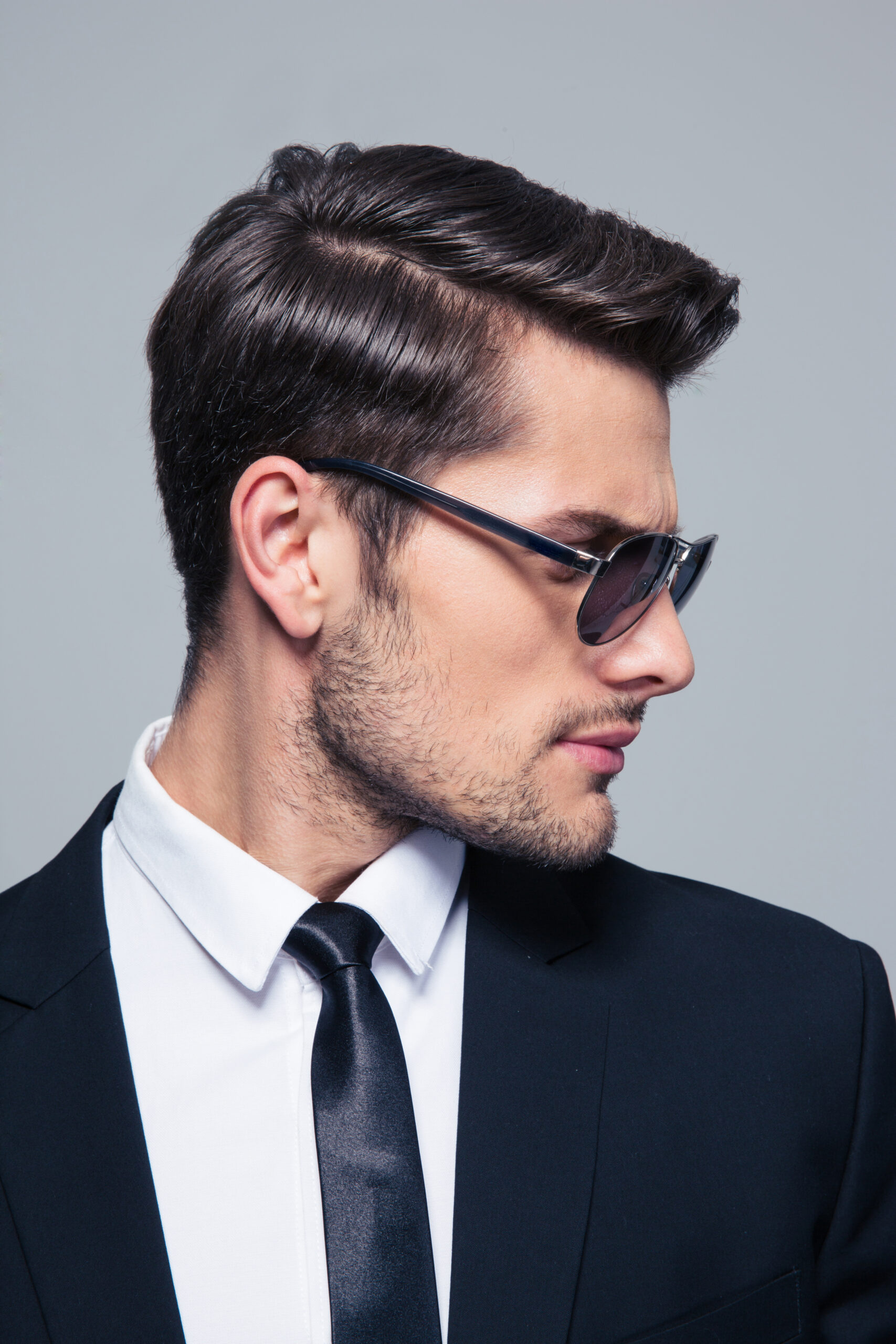 Businessman in sunglasses looking away